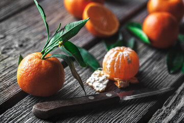 tangerines with a knife on a wooden background. Healthy food. Fruit