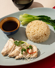 Hainanese chicken rice is a dish consisting of delicious steamed white chicken cut into pieces and served over fragrant rice
