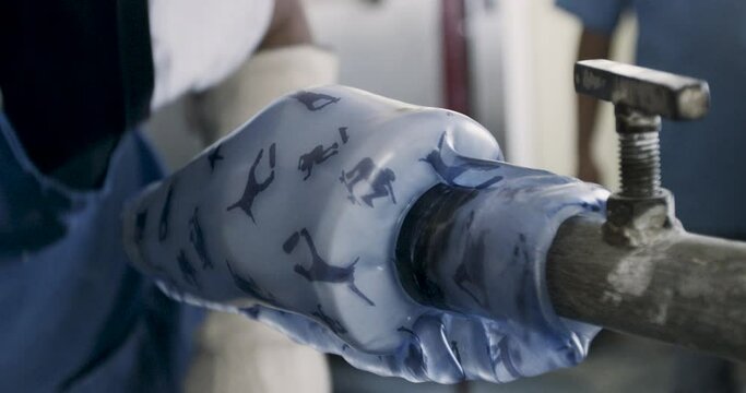 Cutting melted plastic pattern on prothetic leg - close up
