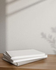 Books on a wooden table against the grey wall with daylight shadow. Pedestal for showcasing products