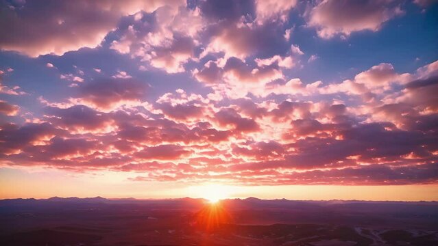 The sun is setting over a vast body of water, casting a warm glow on the horizon.