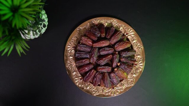 a plate with dates and a green plant