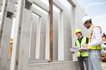 Engineer team discuss and examine a building construction.