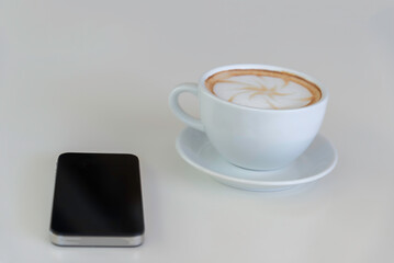 Hot latte art coffee cup on wooden table