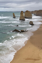 Twelve Apostles rock formations with a sandy beach and ocean waves on the Great Ocean Road in Victoria, Australia