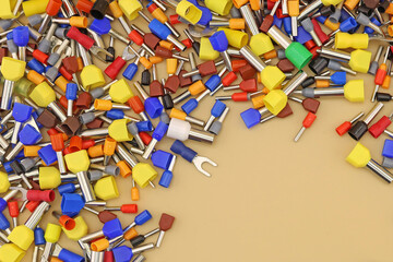 Metal tips with a plastic insulator for connecting copper electrical wires. Close-up. Soft focus. 