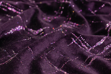 Purple glitter velvet fabric texture used as background.