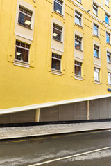 Bright yellow facade of a modern building. Geometry in an urban environment.