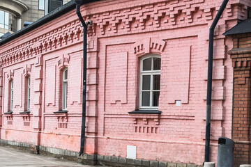 Fototapeta premium Brick pink facade of an ancient merchant building in Moscow.