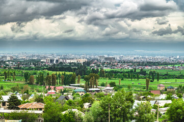 Panorama of the city of Bishkek on a cloudy spring day before rain.