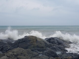 Image of a wave crashing on the rock