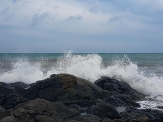 Image of a wave crashing on the rock