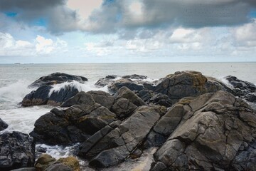 Image of a wave crashing on the rock