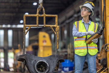 Maintenance engineer uses machine to lift and replace locomotive parts, reducing carbon emissions.