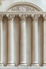 Fototapeta premium Three tall and narrow columns with white trim display symbolic elements and arched doorways in beige.