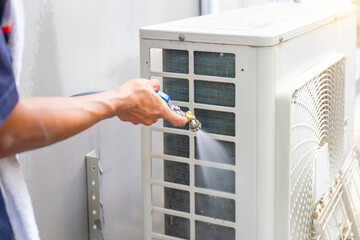 Technician man clean air conditioning system, Repairman washing dirty inside the compartments air...