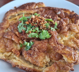 Freshly prepared Asian deep-fried crispy egg omelet.