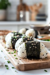Traditional onigiri rice balls neatly arranged on a wooden platter, each wrapped with a strip of nori and garnished with sesame seeds, bright kitchen setting, eyelevel shot