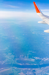 Aerial view from airplane window above green ground. View from the airplane window with beautiful...