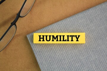 glasses and paper colored with the word Humility