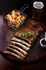 meat and bones of barbecue ribs half eaten with portion of potatoes