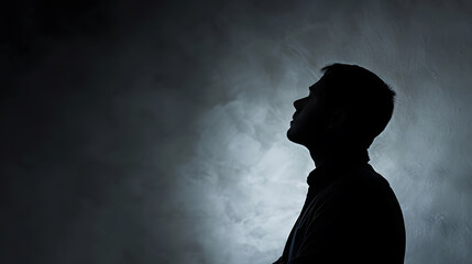 Man silhouette thinking about problem or trouble at work on gray studio wall Anonym concept : Generative AI