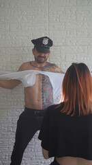 Man in policeman costume performing an striptease show