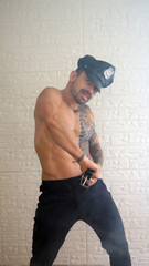 Man in policeman costume performing an striptease show