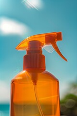 orange blank sunscreen spray bottle blue sunny sky in the background