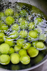 Green plum in water