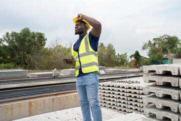 Portrait African American engineer man use tablet computer checking precast cement at precast...