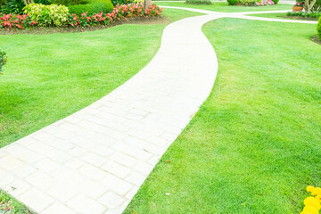 Walkway pathway s curve in public park,Lawn with curved paved garden path,Garden landscape design in flower garden,Selective focus,copy space.