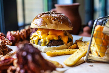 Cheeseburger and French Fries on Table