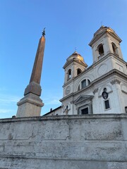 obelisk and church Trinita dei Monti on the top of the Spanish steps in Rome