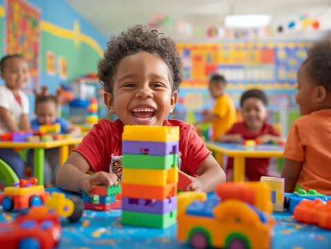A preschool boy is playing with colorful plastic blocks in a classroom.