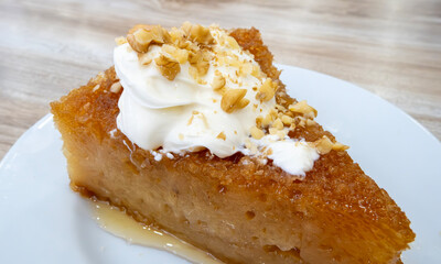 Sherbet bread kadayif dessert. Turkish Ramadan dessert. Bread kadayif dessert with cream on a marble serving plate. Local name kaymaklı ekmek kadayıfı