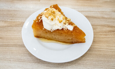 Sherbet bread kadayif dessert. Turkish Ramadan dessert. Bread kadayif dessert with cream on a marble serving plate. Local name kaymaklı ekmek kadayıfı
