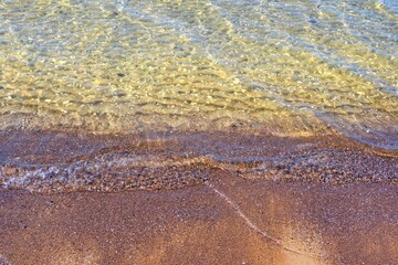 Reflections of clear water on a shallow sandy beach bottom. Clear water. Sandy shore.
