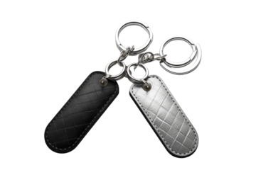 Duality in Shadow: Twin Black and Silver Leather Key Chains on White or PNG Transparent Background.
