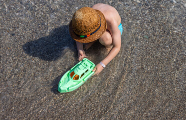 cute kid with hat on beach against sea or is having fun in summer vacation.boy with snorkel, diving...