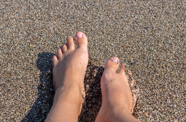 woman girl feet on beach against sea. steps on sands. relax in summer vacation concept. 