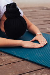 fitness, sport and healthy lifestyle concept - woman doing yoga exercise on the beach, rest pose in yoga