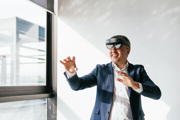 A businessman in a suit uses a VR headset, showcasing augmented reality technology in a sleek,...