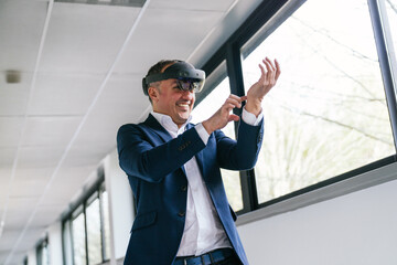 A businessman in a suit uses a VR headset in an office hallway, exploring the capabilities of...