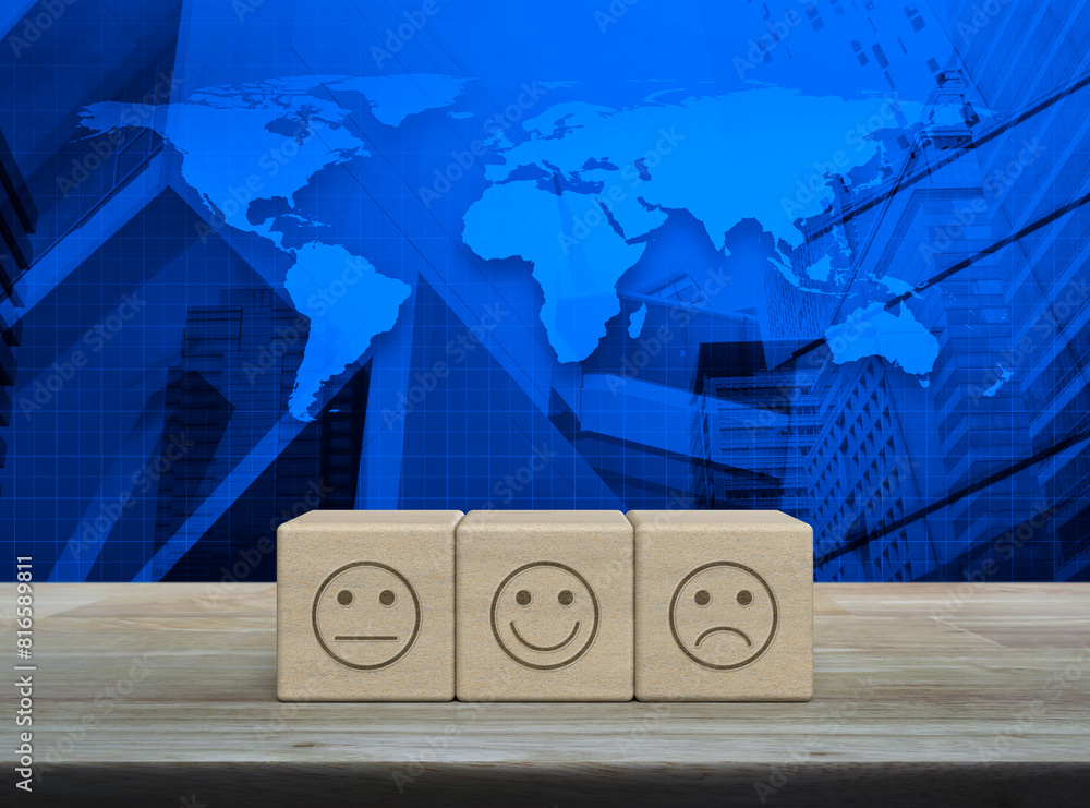 Poster excellent smiley face rating icon on block cubes on table over world map and city tower, business cu