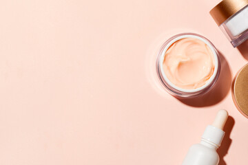 Skin care border - open jar of pink beauty cream