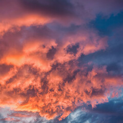 "A canvas of clouds ablaze with the hues of sunset."
