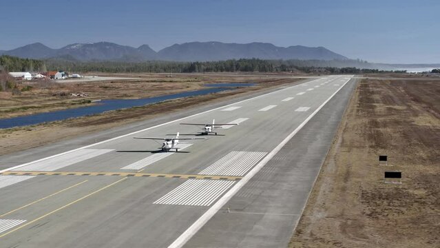 Aerial View of Two Propeller Airplanes on the Runway - Sunny Day