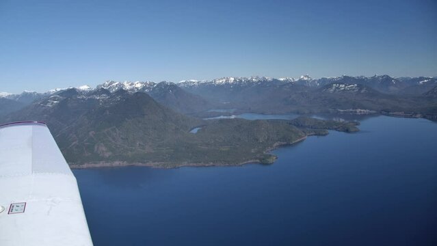 Leading Edge of Propeller Airplane in Flight with Pacific Northwest Coastline on a Sunny Day - Private Pilot's View Flying