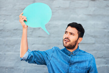 Speech bubble, man and thinking by wall for social media, comment and opinion in city. Text box,...